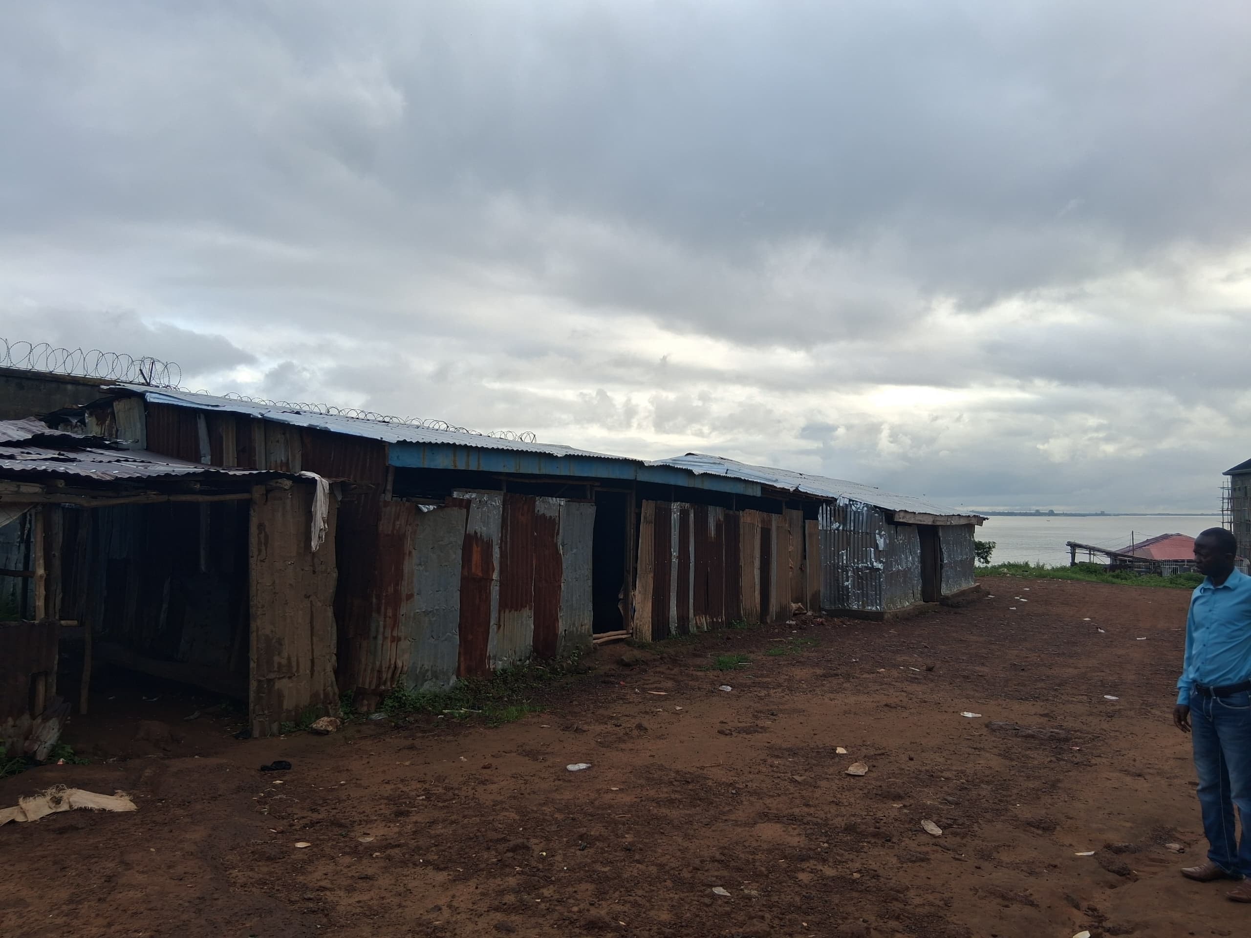 Side view of the school exterior showing the full length of the zinc sheet structure along the waterfront